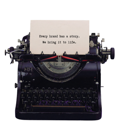 A typewriter with a page reading: Every brand has a story. We bring it to life.